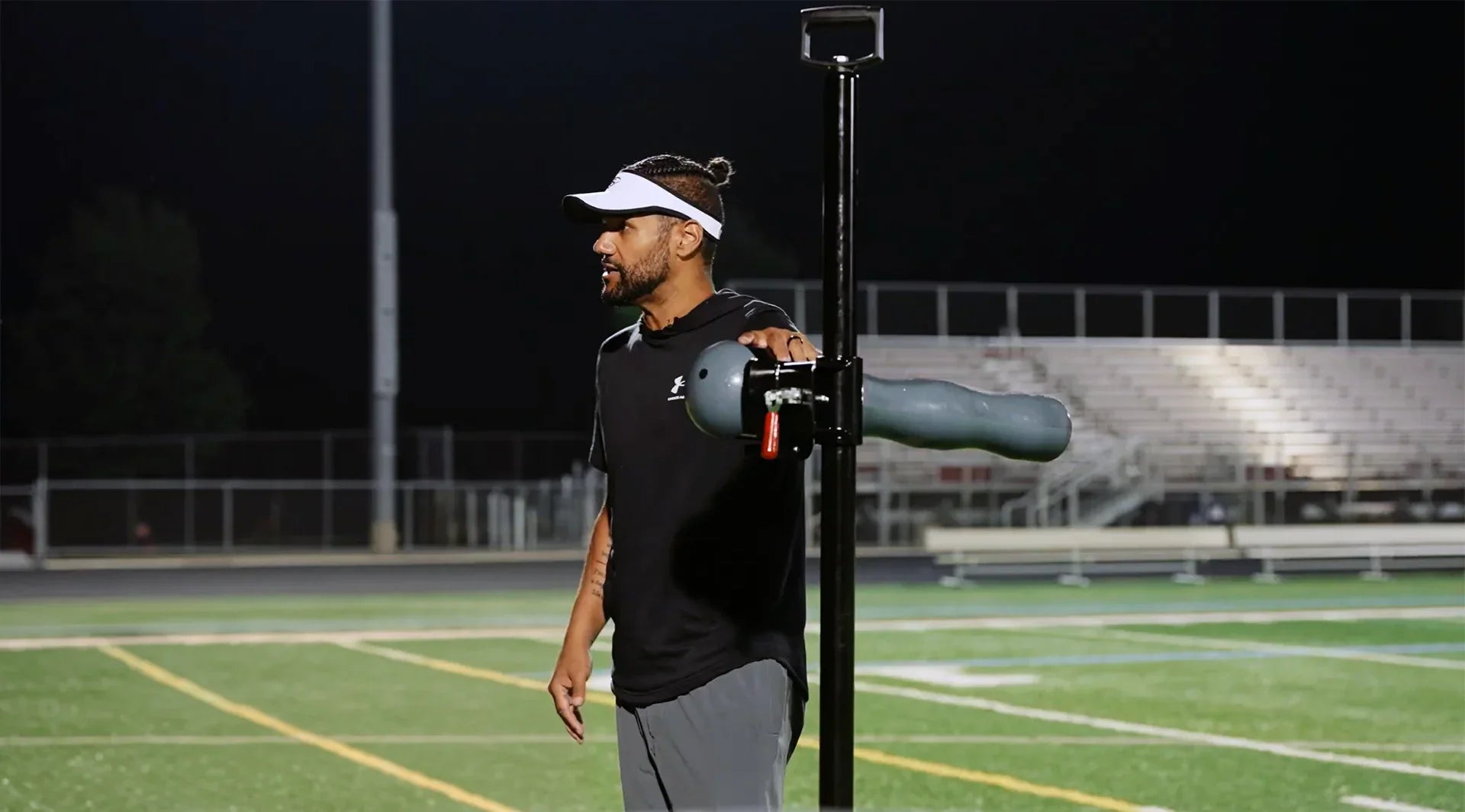 Half-Gate founder coaching football players on proper leverage and pad level using the Half-Gate football training equipment on the field